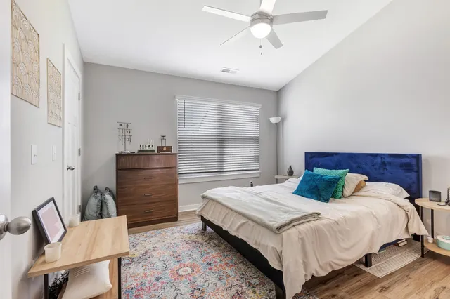 a bedroom with a bed and ceiling fan