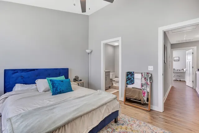 a bedroom with a bed and wooden floor