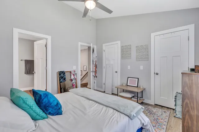 a bedroom with a bed and a chandelier