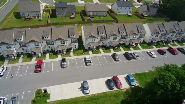 an aerial view of houses with street