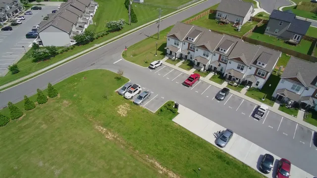 an aerial view of a house with a garden and swimming pool
