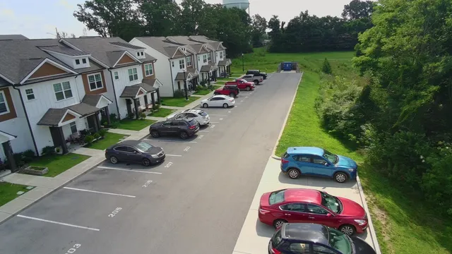 an aerial view of multiple houses with yard