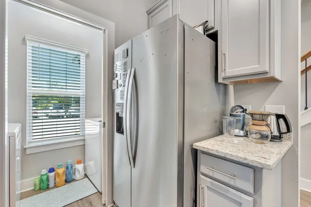 a kitchen with stainless steel appliances granite countertop a refrigerator and a sink