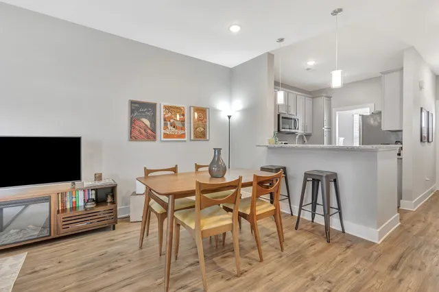 a view of a dining room with furniture and wooden floor