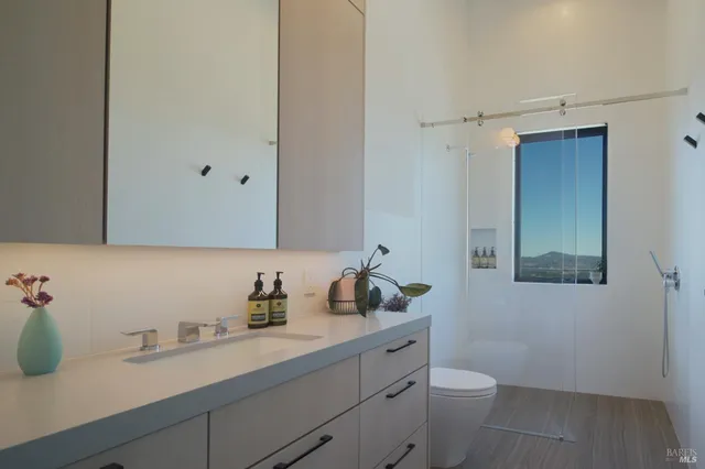 a bedroom with a bed and a potted plant