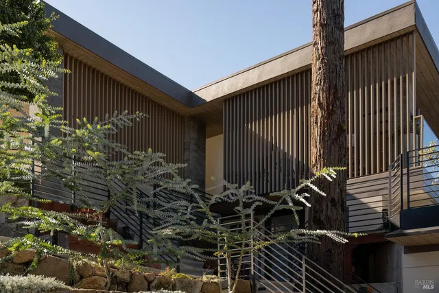 a kitchen with stainless steel appliances granite countertop a sink a stove and cabinets