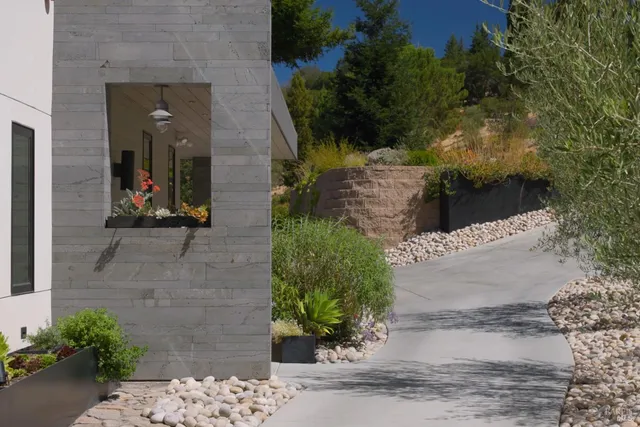 a front view of a house with garden