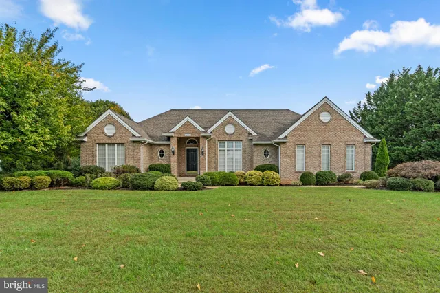 a view of a house with a big yard and potted plants