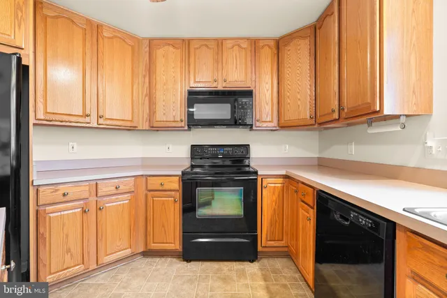 a kitchen with stainless steel appliances granite countertop a refrigerator and a stove