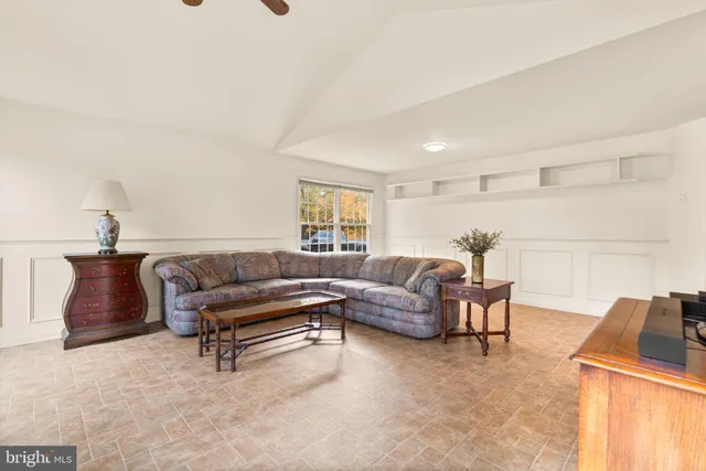a bedroom with a bed and a dresser next to a window