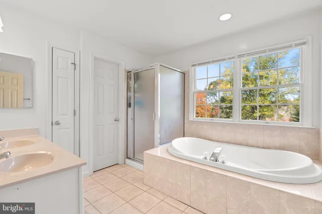 a bed sitting in a room next to a window