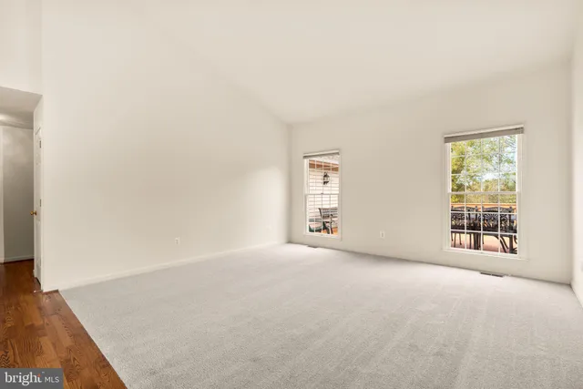 a view of a livingroom with wooden floor and furniture