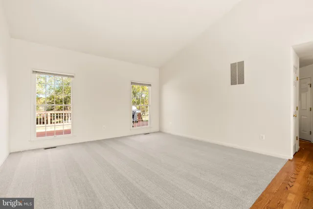 a view of a livingroom with a chair and wooden floor