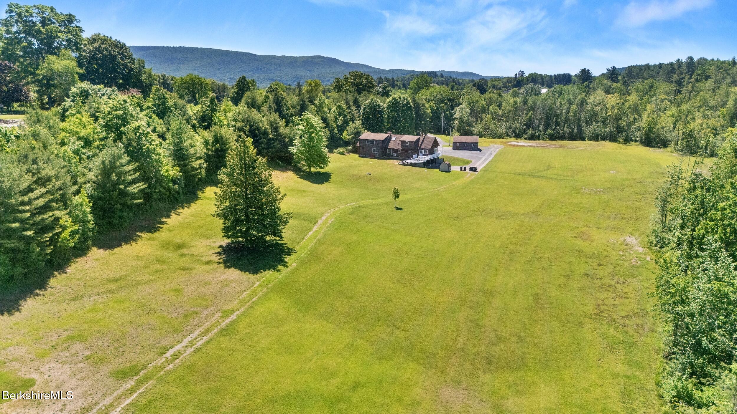 134 Hurlburt Road Great Barrington, MA 01230 - Photo 11 of 50 a view of a lake with a mountain in the background