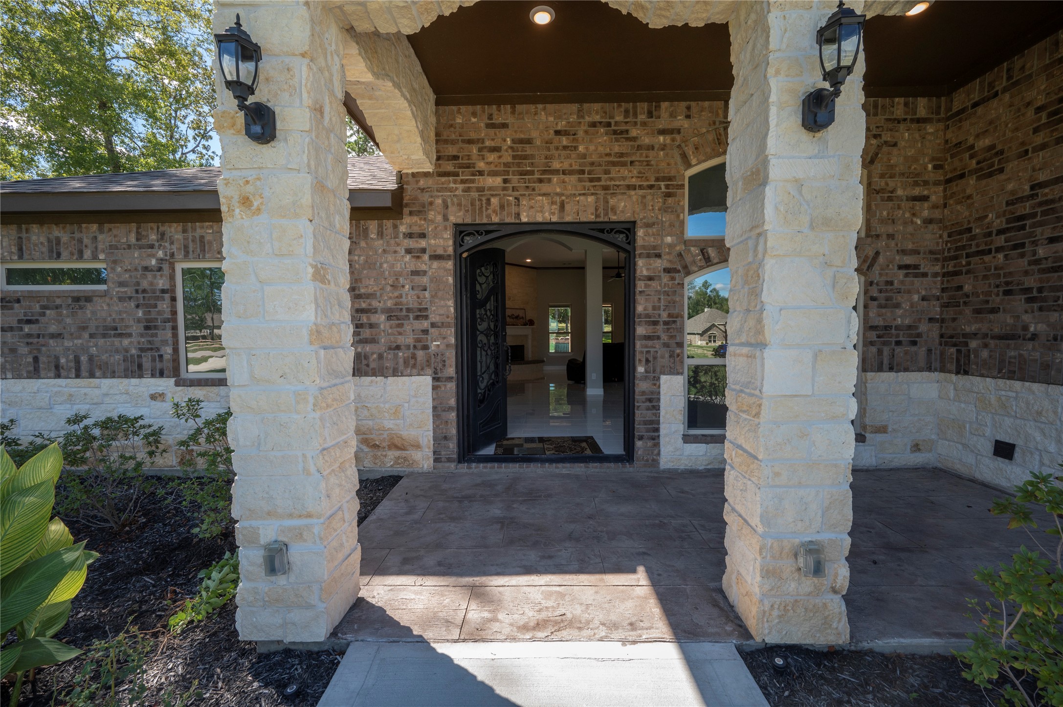 320 Dahlia Road Huntsville, TX 77320 - Photo 7 of 50 Elegant stone entry with wood look stamped concrete flooring