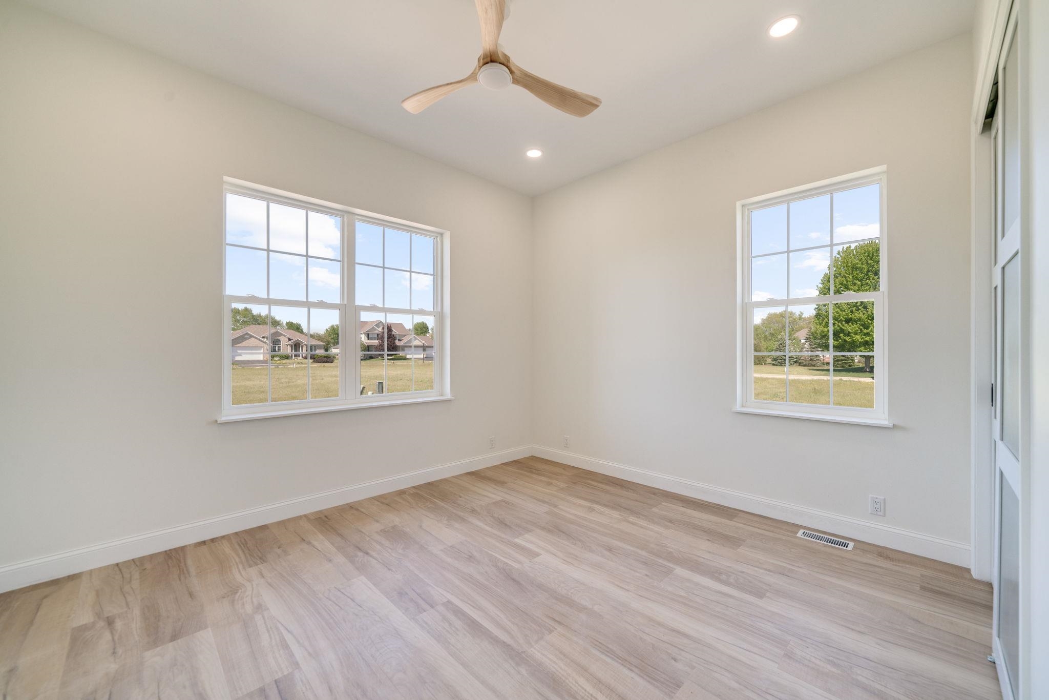 5145 Sycamore Ridge Road Belvidere, IL 61008 - Photo 33 of 57 a view of an empty room with wooden floor and a window