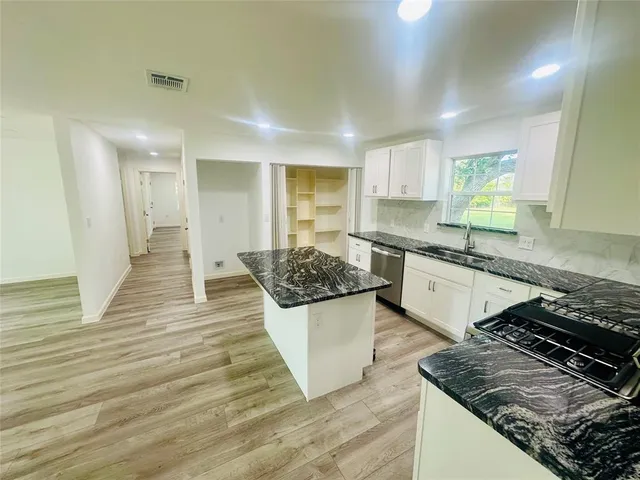a kitchen with a sink and a stove top oven