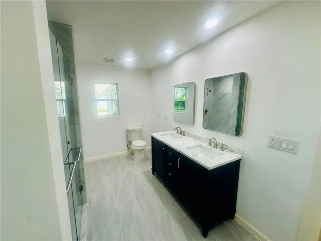 a bathroom with a sink vanity and mirror