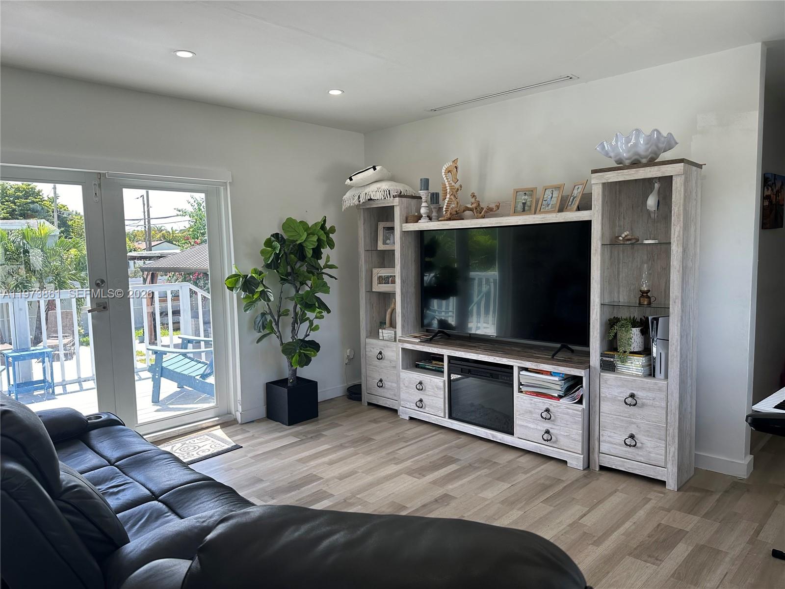 2401 Southwest 83rd Avenue Miami, FL 33155 - Photo 13 of 21 a living room with furniture and a flat screen tv