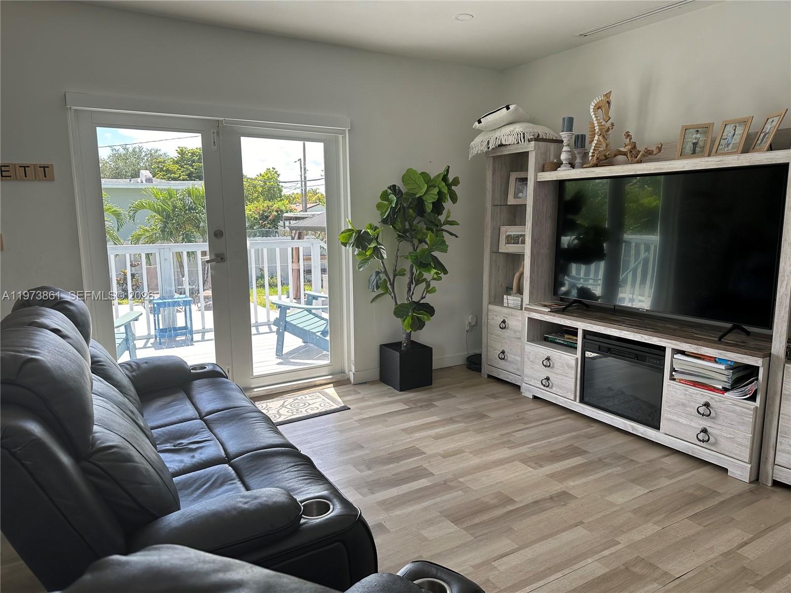 2401 Southwest 83rd Avenue Miami, FL 33155 - Photo 14 of 21 a living room with furniture and a flat screen tv