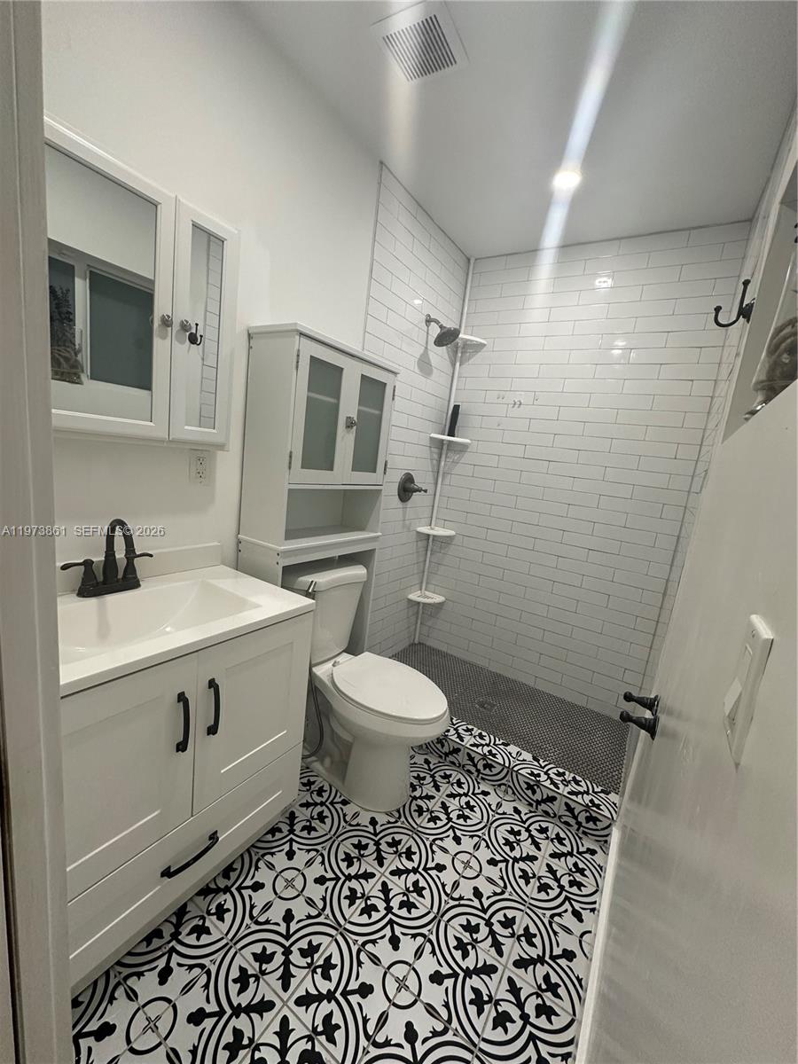 2401 Southwest 83rd Avenue Miami, FL 33155 - Photo 19 of 21 a bathroom with a sink toilet vanity and shower