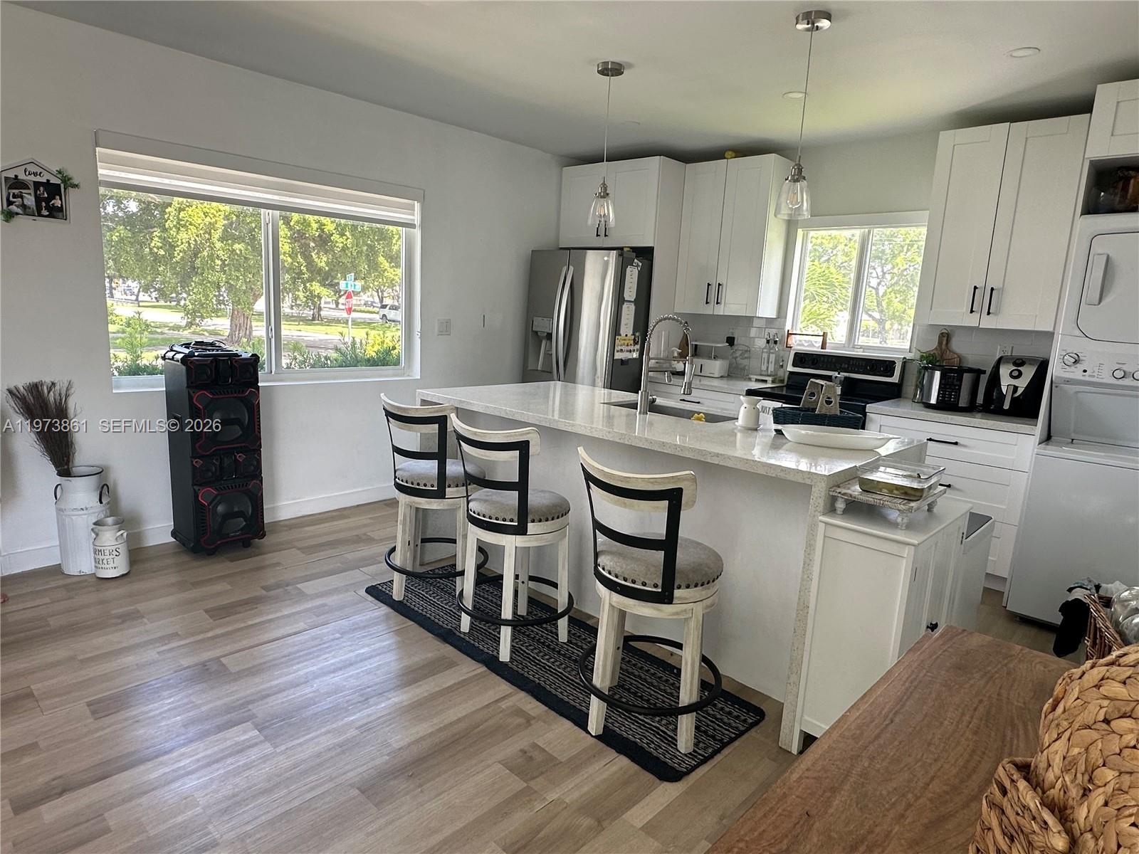 2401 Southwest 83rd Avenue Miami, FL 33155 - Photo 7 of 21 a kitchen with sink cabinets and wooden floor