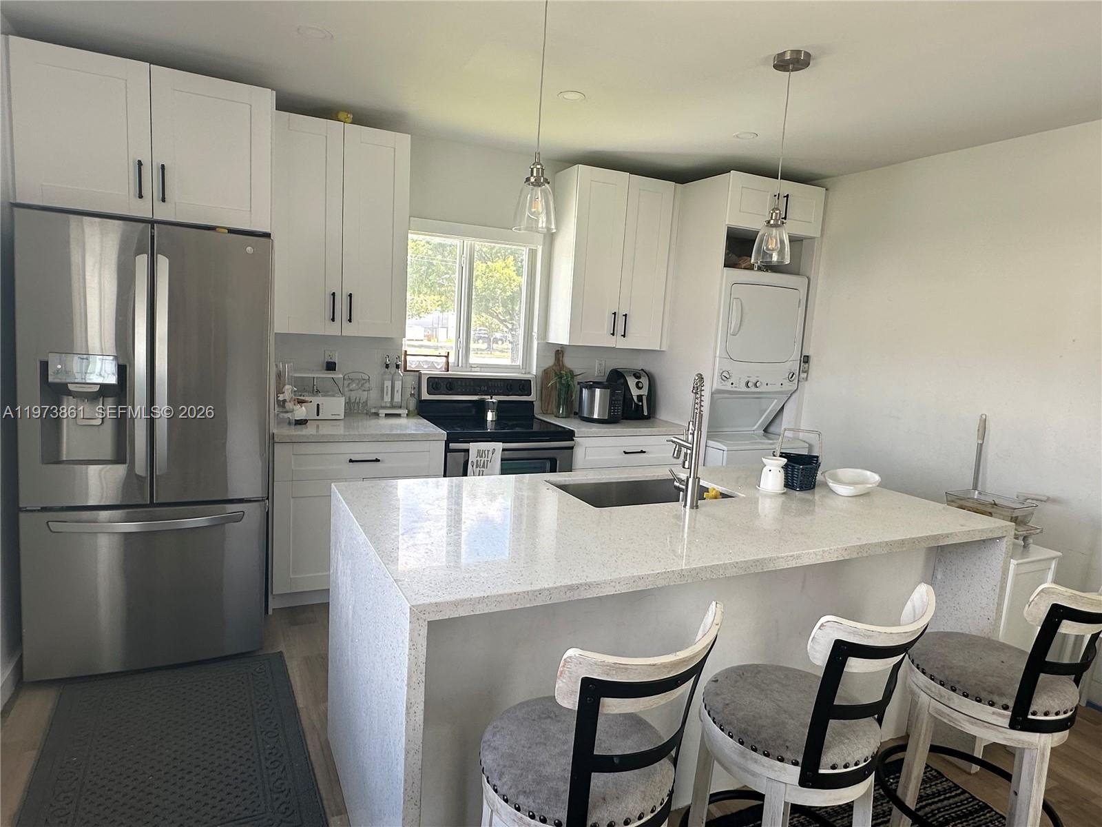 2401 Southwest 83rd Avenue Miami, FL 33155 - Photo 8 of 21 a kitchen with refrigerator and white cabinets