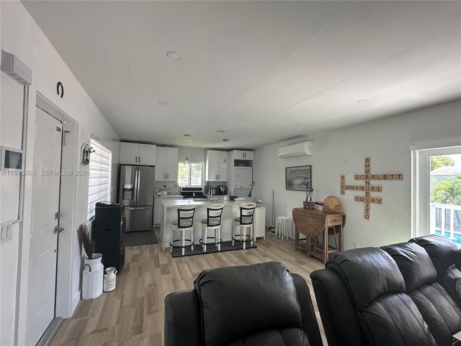 2401 Southwest 83rd Avenue Miami, FL 33155 - Photo 10 of 21 a living room with furniture a fireplace and a flat screen tv
