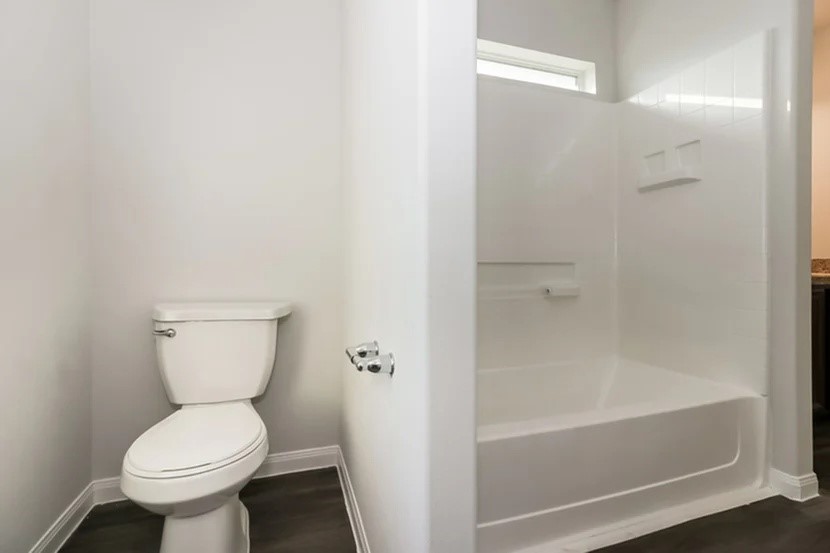 12615 Lady Slipper Road Houston, TX 77038 - Photo 10 of 13 a bathroom with a toilet and a bathtub