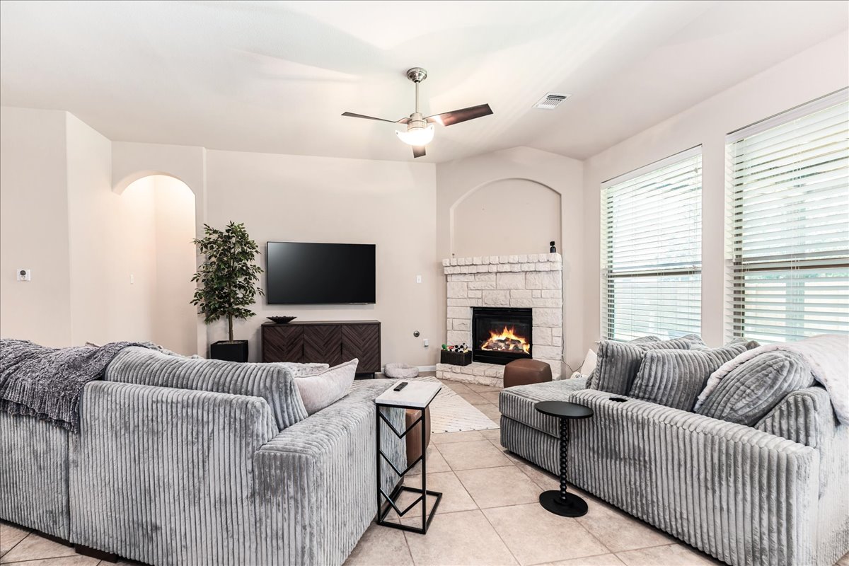 137 Navigator Drive Austin, TX 78717 - Photo 5 of 18 a living room with furniture a flat screen tv and a fireplace