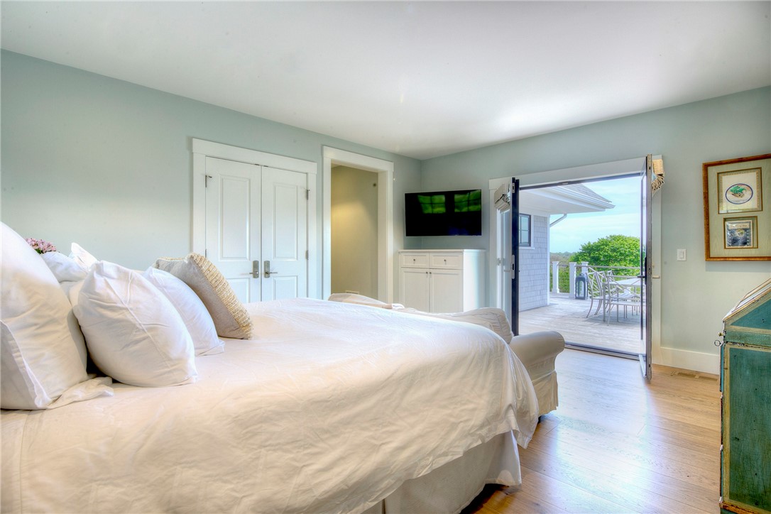 444 Purgatory Lane Middletown, RI 02842 - Photo 27 of 49 1st Floor primary en-suite bedroom with doors to deck overlooking the water.