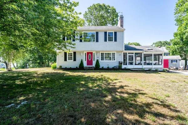 a front view of a house with a garden