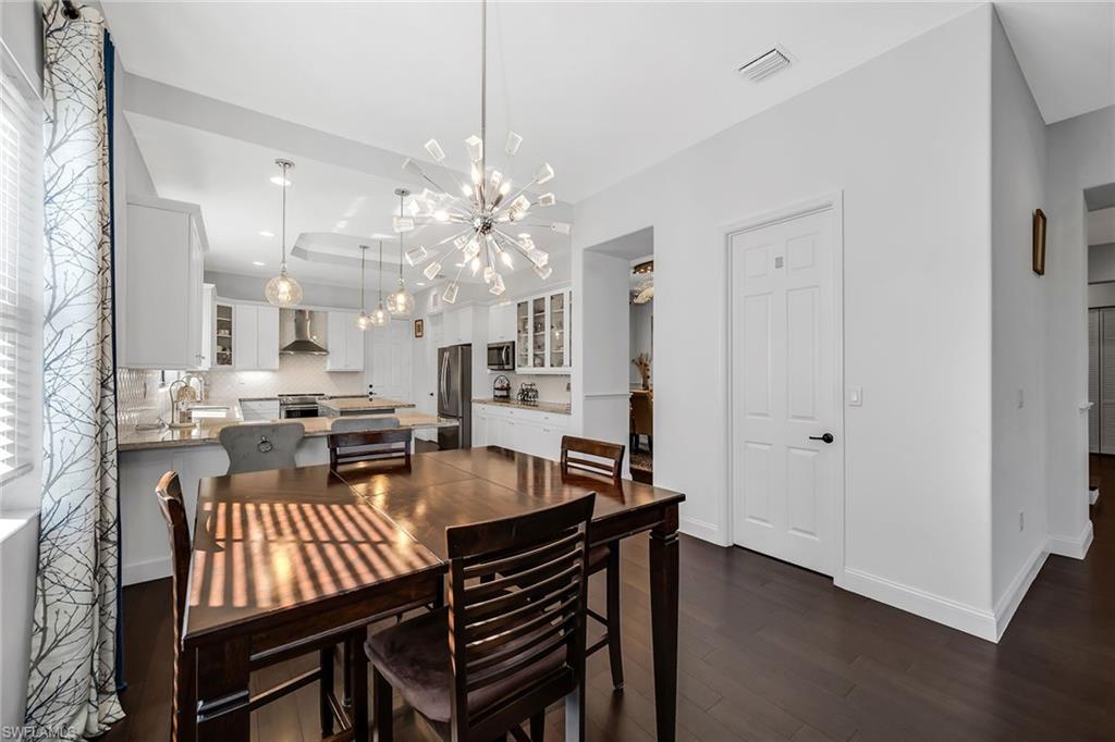 5344 Chandler Way Ave Maria, FL 34142 - Photo 14 of 47 a view of a dining room with furniture and wooden floor