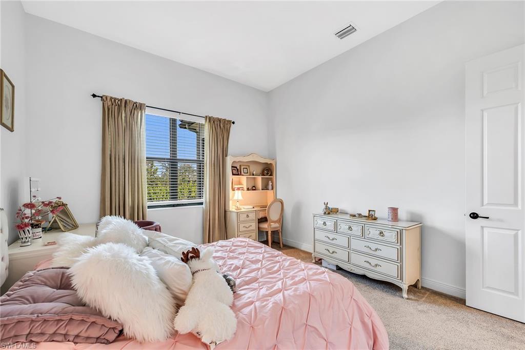 5344 Chandler Way Ave Maria, FL 34142 - Photo 19 of 47 a bedroom with a bed dresser and a window