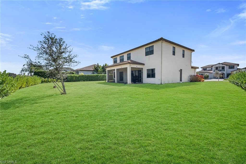 5344 Chandler Way Ave Maria, FL 34142 - Photo 2 of 47 a view of a house with a yard