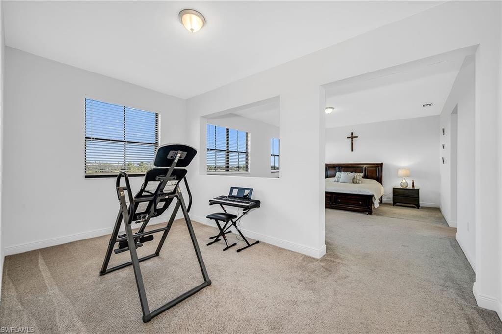 5344 Chandler Way Ave Maria, FL 34142 - Photo 25 of 47 a view of a room with gym equipment and windows