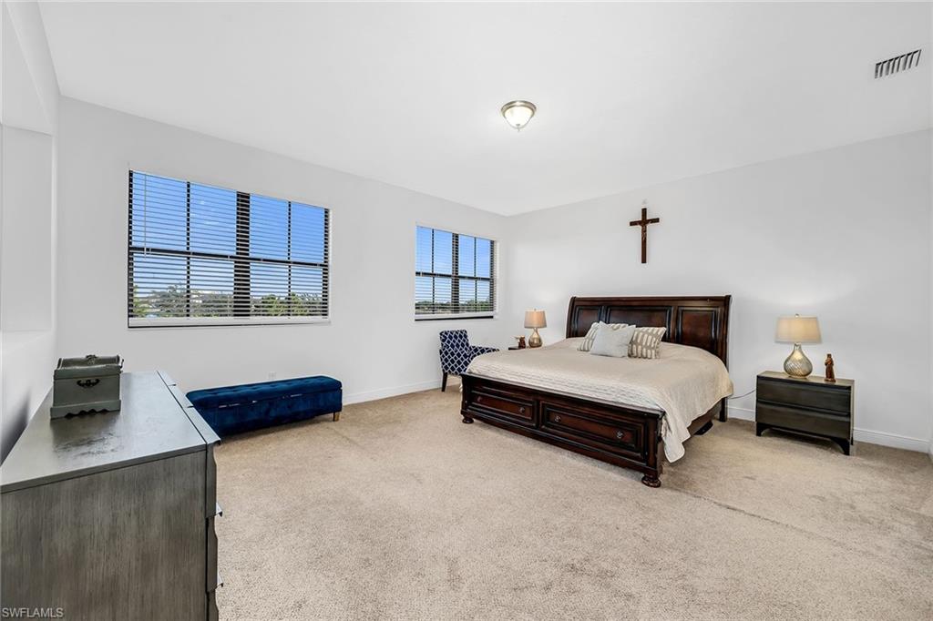 5344 Chandler Way Ave Maria, FL 34142 - Photo 26 of 47 a bedroom with a bed and a night stand