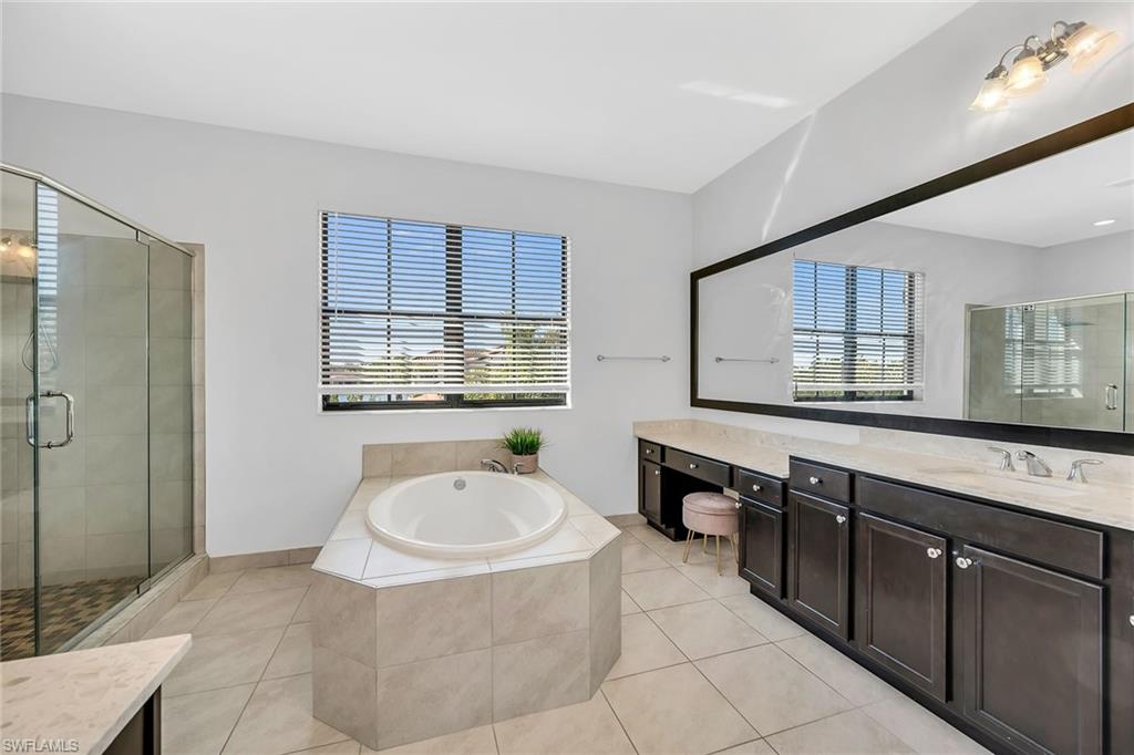 5344 Chandler Way Ave Maria, FL 34142 - Photo 28 of 47 a spacious bathroom with a tub sink and mirror