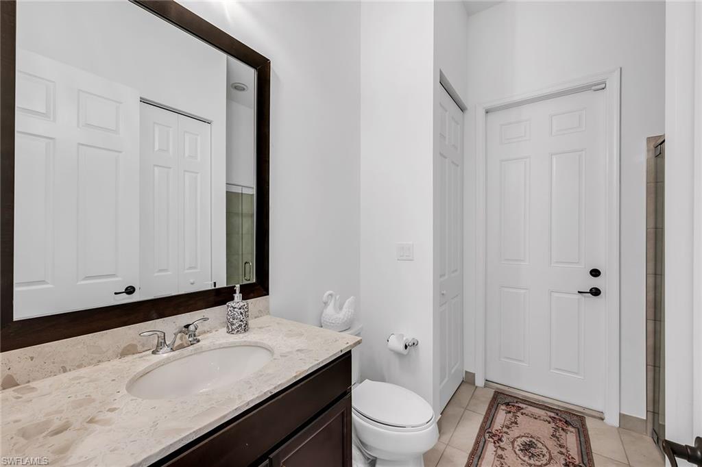 5344 Chandler Way Ave Maria, FL 34142 - Photo 30 of 47 a bathroom with a sink toilet vanity and shower