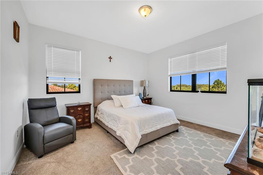 5344 Chandler Way Ave Maria, FL 34142 - Photo 34 of 47 a bedroom with a bed and a couch