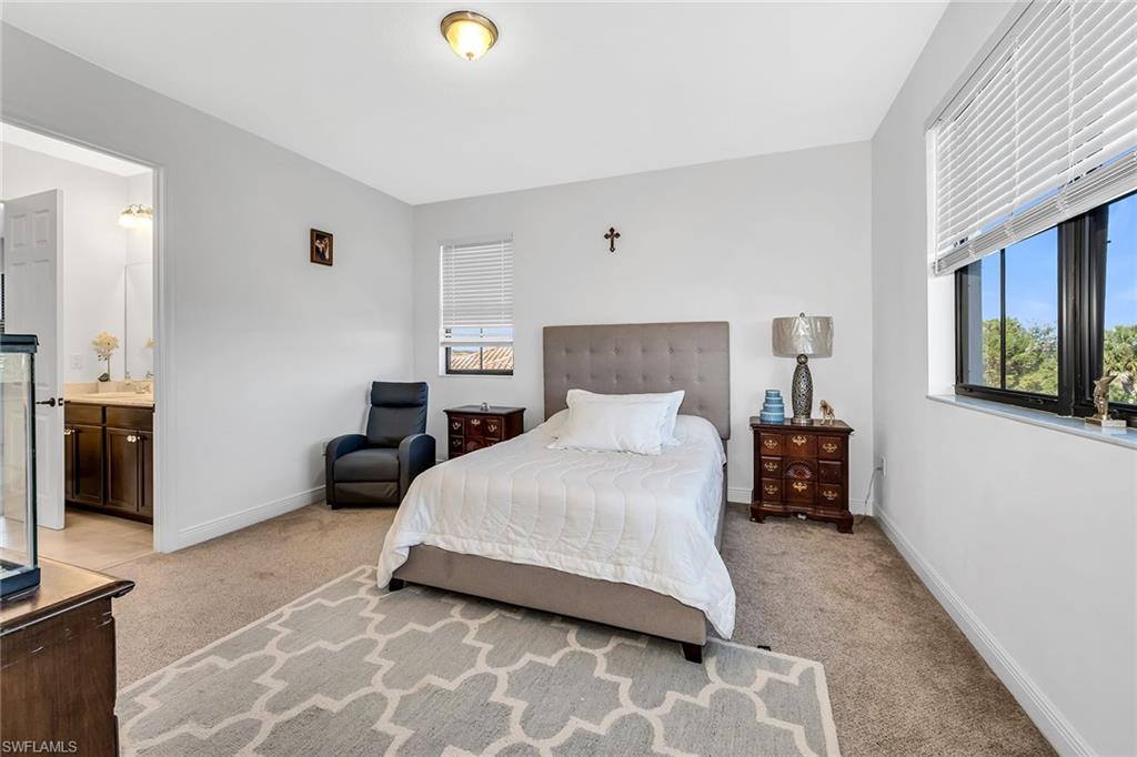 5344 Chandler Way Ave Maria, FL 34142 - Photo 35 of 47 a bedroom with a bed and a couch