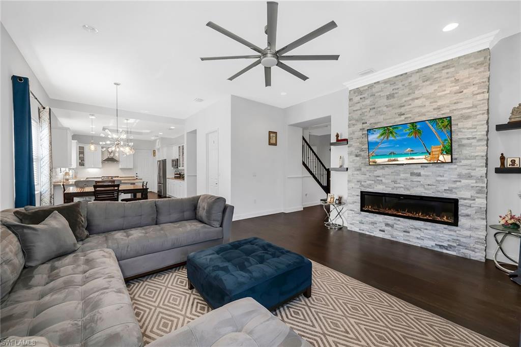 5344 Chandler Way Ave Maria, FL 34142 - Photo 4 of 47 a living room with furniture a flat screen tv and a fireplace