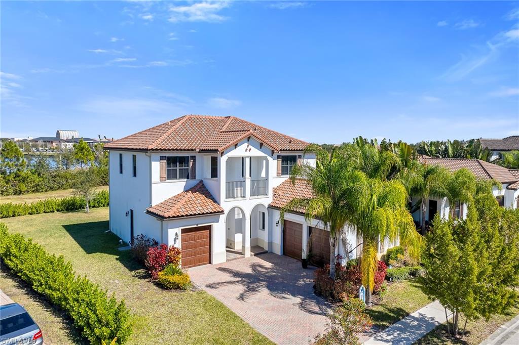 5344 Chandler Way Ave Maria, FL 34142 - Photo 41 of 47 a front view of a house with a yard