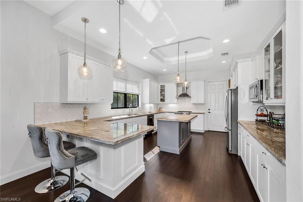 5344 Chandler Way Ave Maria, FL 34142 - Photo 10 of 47 a kitchen with a table chairs refrigerator and cabinets