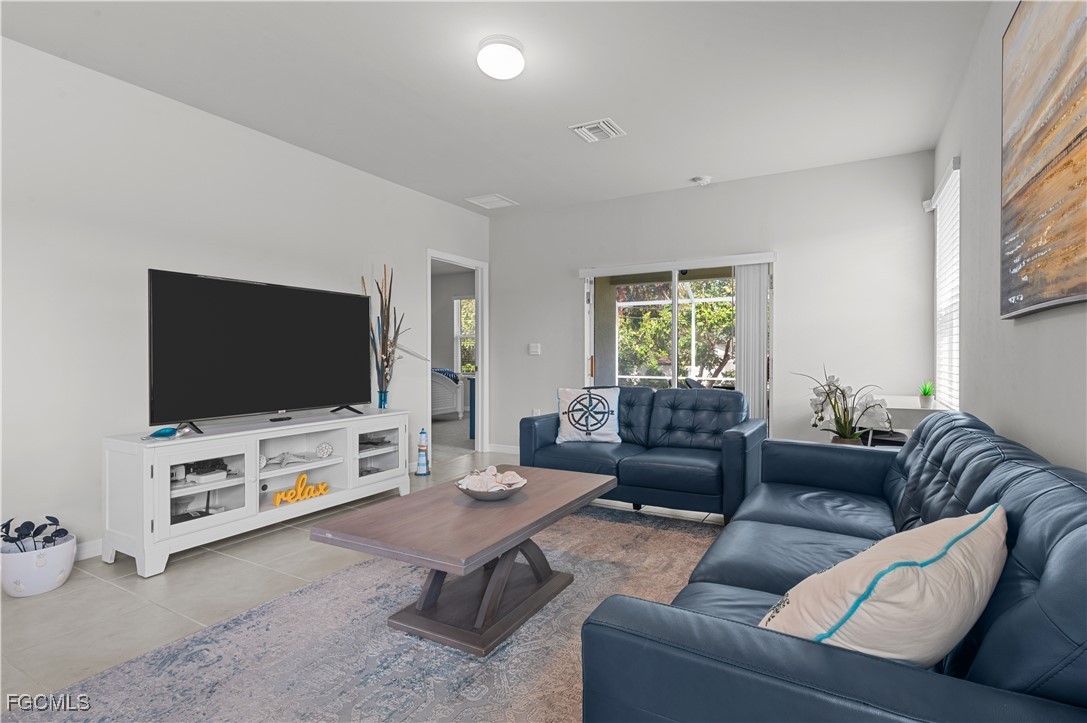 4320 Little Hickory Road Bonita Springs, FL 34134 - Photo 11 of 27 a living room with furniture and a flat screen tv