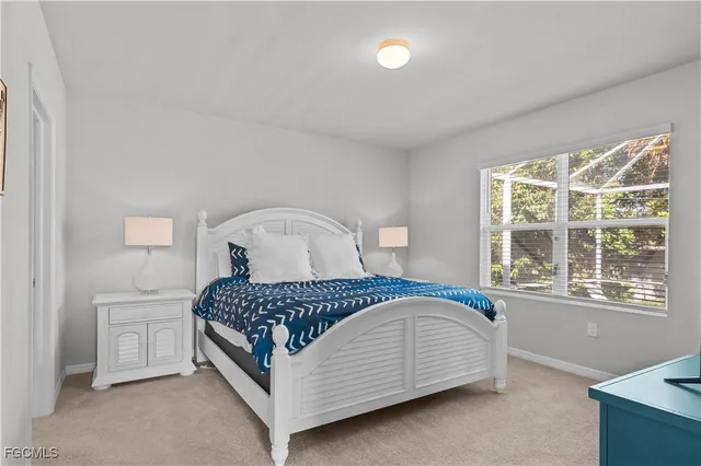 a bedroom with a bed next to a window with a dresser