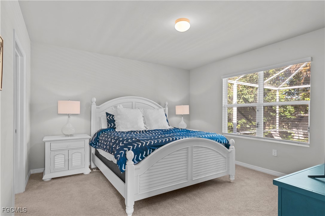 4320 Little Hickory Road Bonita Springs, FL 34134 - Photo 17 of 27 a bedroom with a bed next to a window with a dresser