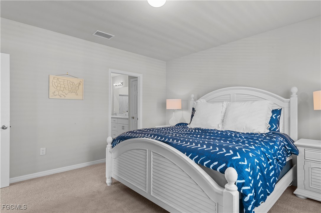 4320 Little Hickory Road Bonita Springs, FL 34134 - Photo 18 of 27 a bedroom with a bed and a night stand