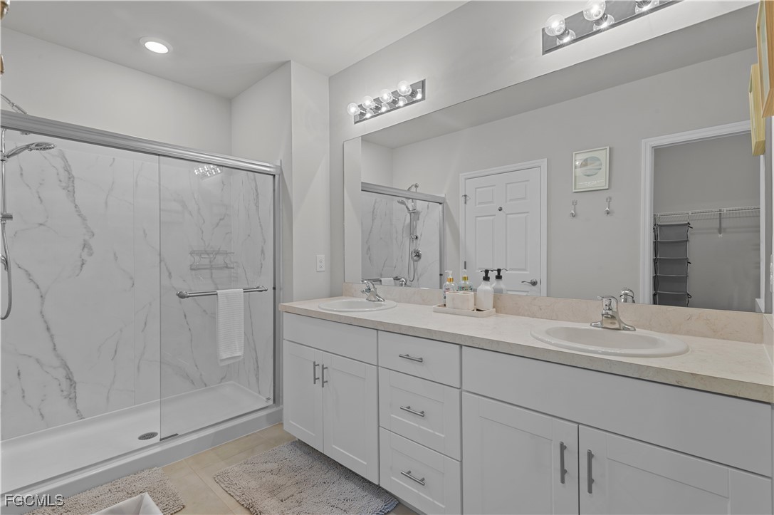 4320 Little Hickory Road Bonita Springs, FL 34134 - Photo 19 of 27 a bathroom with a double vanity sink mirror and shower