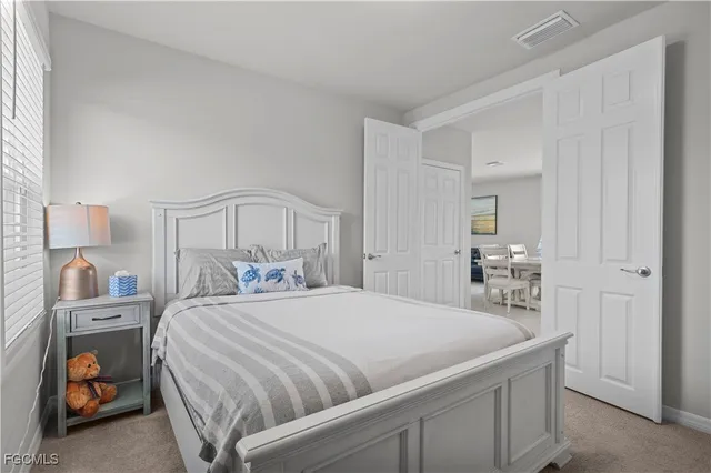 a bedroom with a bed and a lamp